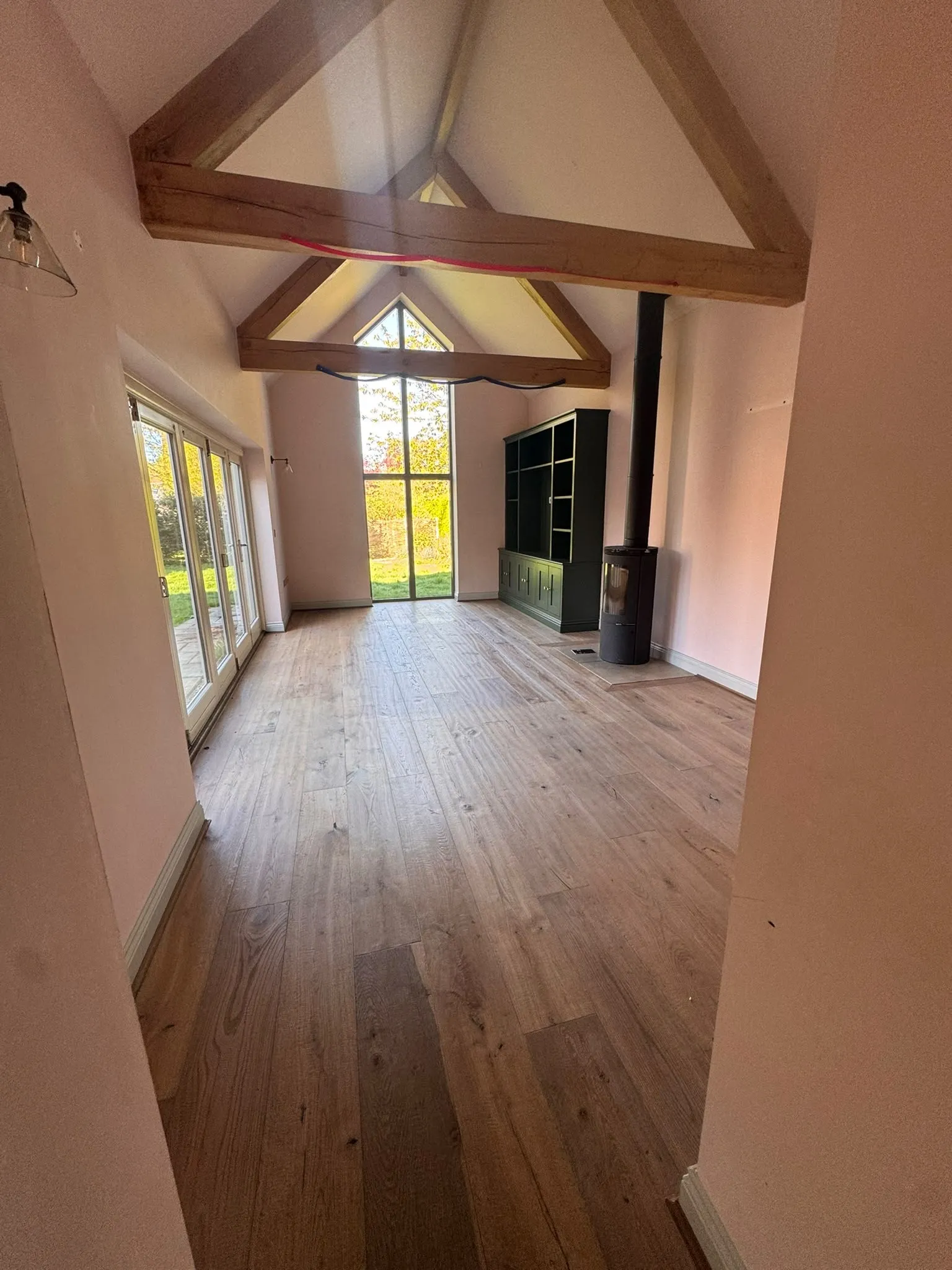 Vaulted living room with exposed oak beams, freshly painted walls and new oak floor
