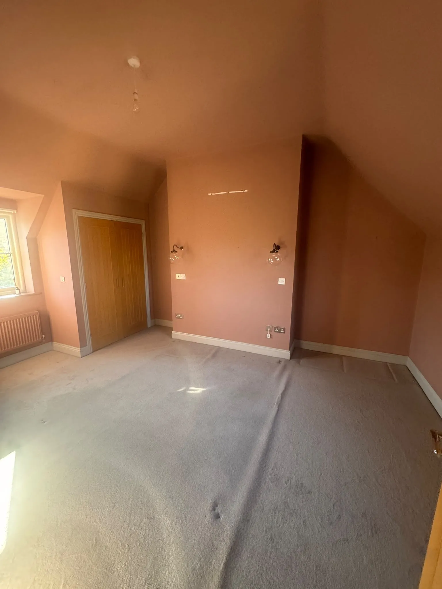 Bedroom painted in a warm terracotta tone