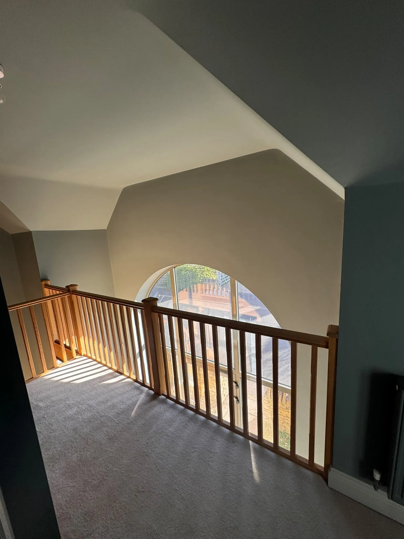 Landing with arched window and newly painted walls